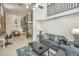 Open living space with spiral staircase, dining area, and exposed brick at 377 King St # 101, Charleston, SC 29401