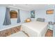 Bright bedroom with hardwood floors and a view of a brick wall at 377 King St # 101, Charleston, SC 29401