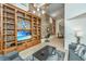Living area with large bookcase, TV, and loft access at 377 King St # 101, Charleston, SC 29401