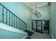 Elegant entryway with chandelier, clock, and staircase at 377 King St # 101, Charleston, SC 29401