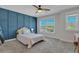 Bright bedroom with a pink bed, blue accent wall, and large window at 601 Yellow Leaf Ln, Summerville, SC 29486