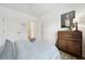 Cozy bedroom with a wooden dresser, a bed with blue bedding, and a guitar at 420 Carolina Cherry Ct # 102, Charleston, SC 29414