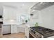 Modern white kitchen with stainless steel appliances and herringbone backsplash at 420 Carolina Cherry Ct # 102, Charleston, SC 29414