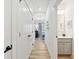 Bright hallway with light wood floors, leading to bedrooms and a bathroom at 420 Carolina Cherry Ct # 102, Charleston, SC 29414