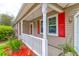 Front porch with white railings and red shutters at 107 Amberjack Way, Summerville, SC 29485