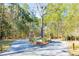 Community entrance with paved road and lush landscaping at 1709 Vireo Ct, Johns Island, SC 29455