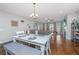 Spacious dining area with white farmhouse table and gray bench seating at 513 Abigail St, Moncks Corner, SC 29461