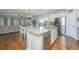 Open kitchen with granite island, stainless steel appliances and hardwood floors at 513 Abigail St, Moncks Corner, SC 29461