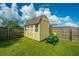 Tan shed with green lawnmower in backyard at 513 Abigail St, Moncks Corner, SC 29461