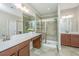 Double vanity bathroom with a large walk-in shower and tiled floors at 513 Abigail St, Moncks Corner, SC 29461