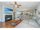 Living room features a cozy fireplace, sectional sofa, and hardwood floors at 513 Abigail St, Moncks Corner, SC 29461