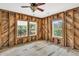 Bedroom with three windows and ceiling fan, under renovation at 410 Four Holes Road, Dorchester, SC 29437