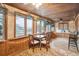 Bright sunroom with water views, seating and dining areas at 924 W Oceanview Rd, Charleston, SC 29412