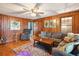 Cozy living room featuring wood paneling, hardwood floors, and comfortable seating at 924 W Oceanview Rd, Charleston, SC 29412