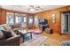 Spacious living room with wood paneling and access to porch at 924 W Oceanview Rd, Charleston, SC 29412