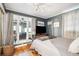 Spacious bedroom with a comfortable bed and access to a sunroom at 924 W Oceanview Rd, Charleston, SC 29412