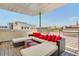 Rooftop patio with sectional seating, red pillows, and city views at 487 King St # 202 Penthouse, Charleston, SC 29403