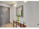 Bright entryway with a sleek mirror and glass-top console table at 487 King St # 202 Penthouse, Charleston, SC 29403