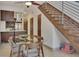 Modern dining area with glass top table and wood chairs near staircase at 487 King St # 202 Penthouse, Charleston, SC 29403