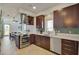 Modern kitchen with stainless steel appliances and dark wood cabinetry at 487 King St # 202 Penthouse, Charleston, SC 29403