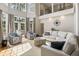 Open living room with sectional sofa, two armchairs and hardwood floors at 2981 Deer Point Dr, Seabrook Island, SC 29455