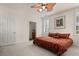 Bright bedroom with king-size bed, ensuite bathroom access, and plantation shutters at 5559 Colonial Chatsworth Cir, North Charleston, SC 29418