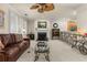 Living room with fireplace, hardwood floors, and leather sofa at 5559 Colonial Chatsworth Cir, North Charleston, SC 29418