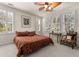 Spacious bedroom with king-size bed, window seating, and plantation shutters at 5559 Colonial Chatsworth Cir, North Charleston, SC 29418