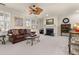 Living room with fireplace, hardwood floors, and leather sofa at 5559 Colonial Chatsworth Cir, North Charleston, SC 29418