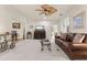 Living room with leather sofa and a view into dining area at 5559 Colonial Chatsworth Cir, North Charleston, SC 29418