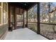 Cozy screened porch overlooking a wooded backyard at 5559 Colonial Chatsworth Cir, North Charleston, SC 29418