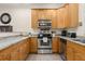 Stainless steel appliances and light wood cabinets in kitchen at 5559 Colonial Chatsworth Cir, North Charleston, SC 29418