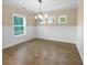 Bright dining room features hardwood floors, wainscoting, and a chandelier at 3699 Shutesbury St, Mount Pleasant, SC 29466