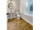 Small powder room with pedestal sink, toilet, and wood-look tile floor at 3699 Shutesbury St, Mount Pleasant, SC 29466