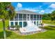 Two-story house with screened porch and landscaped yard at 3238 Plow Ground Rd, Johns Island, SC 29455