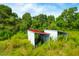 Two metal storage sheds in a wooded area of the property at 3238 Plow Ground Rd, Johns Island, SC 29455