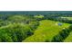 Aerial view of house on large lot with lush green fields and trees at 3238 Plow Ground Rd, Johns Island, SC 29455