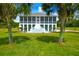 Two-story house with large screened porch and lush green lawn at 3238 Plow Ground Rd, Johns Island, SC 29455