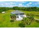 Aerial view of a house with a large yard and surrounding greenery at 3238 Plow Ground Rd, Johns Island, SC 29455