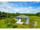 Aerial view of a single-Gathering home with large screened porch and lush landscaping at 3238 Plow Ground Rd, Johns Island, SC 29455