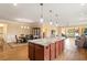 Open concept kitchen with island, granite, and hardwood floors at 586 Eastern Isle Ave, Summerville, SC 29486