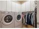 Laundry room with washer, dryer, cabinets, and hanging space at 586 Eastern Isle Ave, Summerville, SC 29486