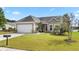 One-story home with attached garage and manicured lawn at 586 Eastern Isle Ave, Summerville, SC 29486