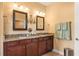 Double vanity bathroom with granite countertops and large mirrors at 586 Eastern Isle Ave, Summerville, SC 29486