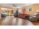 Spacious living room with hardwood floors, comfy seating, and large windows at 586 Eastern Isle Ave, Summerville, SC 29486