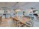 Open concept dining area with a large wooden table and access to kitchen at 3703 Hartnett Blvd, Isle of Palms, SC 29451