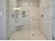 Large walk-in shower with marble tile and built-in seat at 3703 Hartnett Blvd, Isle of Palms, SC 29451
