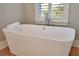 Relaxing bathroom with soaking tub and window shutters at 3703 Hartnett Blvd, Isle of Palms, SC 29451