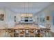 Bright dining room with large wooden table and rustic chairs, offering ample space for entertaining at 3703 Hartnett Blvd, Isle of Palms, SC 29451