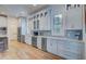 Modern kitchen with white cabinets, stainless steel appliances and light blue backsplash at 3703 Hartnett Blvd, Isle of Palms, SC 29451